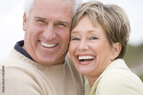 Photo: Couple at the beach smiling Couple at the beach smiling