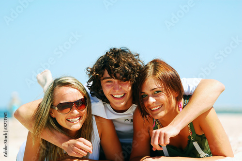 Young friends on the summer beach