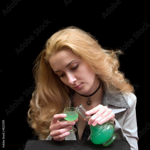 Photo: The long-haired girl with a wine-glass of absinthe liqueur The long-haired girl with a wine-glass of absinthe liqueur