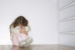 Young girl hugging herself and lonely