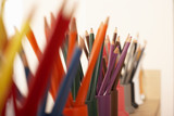 Photo: Row of multi-coloured colouring pencils in pots, close-up (still life, differential focus) Row of multi-coloured colouring pencils in pots, close-up (still life, differential focus)