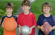 Foto: Three Boys Holding Sports Balls Three Boys Holding Sports Balls