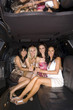 Photo: Medium group of young women with drinks in limousine, reflection in ceiling, smiling, portrait Medium group of young women with drinks in limousine, reflection in ceiling, smiling, portrait