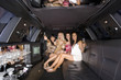 Photo: Medium group of young women with drinks in limousine, reflection in ceiling, smiling, portrait Medium group of young women with drinks in limousine, reflection in ceiling, smiling, portrait