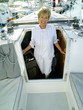 Woman in entrance to cabin of boat, smiling, portrait