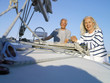 Photo: Mature couple on deck of boat, smiling, portrait, low angle view Mature couple on deck of boat, smiling, portrait, low angle view