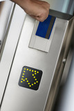 Photo: Person swiping card in entrance barrier, guided by arrow sign, close-up, rear view (tilt) Person swiping card in entrance barrier, guided by arrow sign, close-up, rear view (tilt)