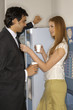Photo: Side view of a businessman and a businesswoman standing in front of a vending machine Side view of a businessman and a businesswoman standing in front of a vending machine