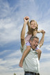 Happy father with daughter on his shoulders