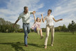 Family swinging daughter in air