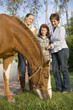 Three generation family with horse