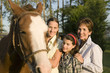 Three generation family with horse