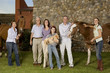 Three generation family portrait with horses and puppy