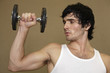 Close-up of a young man exercising with a dumbbell