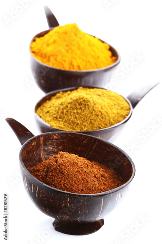 Photo: spices - pile of bright Madras Curry Powder and 2 bowls behind spices - pile of bright Madras Curry Powder and 2 bowls behind