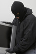 Burglar stealing television set