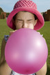 Girl blowing balloon up