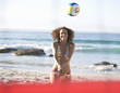 A woman playing beach volleyball