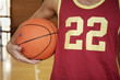 Mid section view of a man holding a basketball