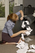 Businesswoman looking in a wastepaper basket