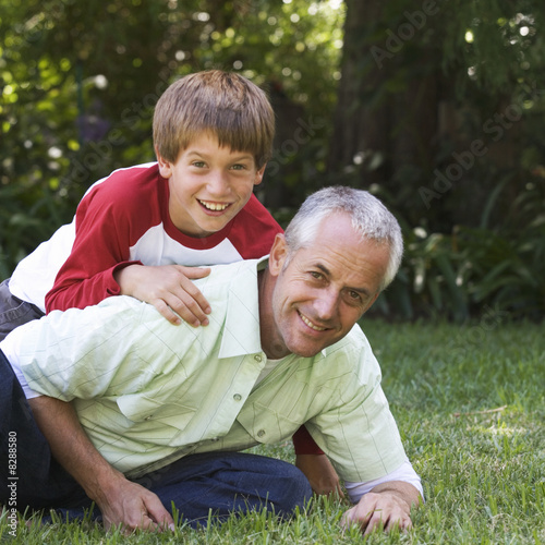 Photo: Father and son playing in a garden Father and son playing in a garden