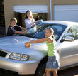 Mother and her children washing a car