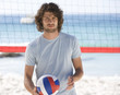 A man playing beach volleyball