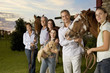 Three generation family portrait with horses and puppy