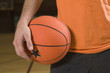 Mid section view of a man holding a basketball