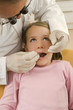 Dentist examining a girl's teeth