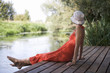 Young woman sitting by a river