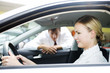 A young woman sitting in a new car