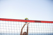 A woman playing beach volleyball