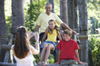 A mother taking a photograph of her husband and children