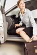 A businesswoman getting out of a car