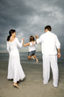 A couple with their daughter on a beach