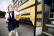 Two schoolgirls running for the school bus