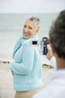 Foto: A senior man filming his partner on a video camera A senior man filming his partner on a video camera