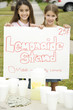 Two young girls at a lemonade stand