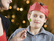 A boy refusing to eat a Brussels sprout