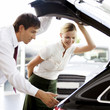 A young woman admiring a new car