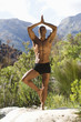 Bare chested young man practicing yoga