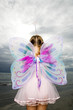 A young girl wearing a fairy costume
