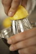 Close-up of a woman's hand squeezing a lemon