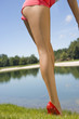 Low section view of a mid adult woman playing golf on a golf course