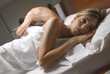 Couple ignoring each other in bed