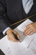 Mid section view of a lawyer filling a form