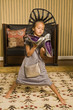 Foto: Girl holding a pair of sandals Girl holding a pair of sandals