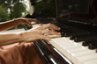 Mid section view of a woman playing a piano