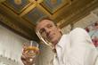 Low angle view of a mature man holding a glass of whiskey